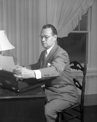 Backus, William at typewriter